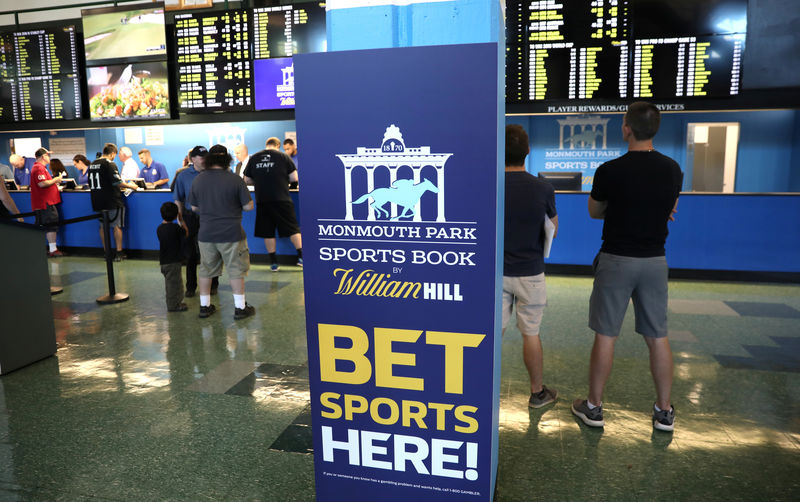 © Reuters. Gamblers place bets on sports at Monmouth Park Sports Book by William Hill, shortly after the opening of the first day of legal betting on sports in Oceanport