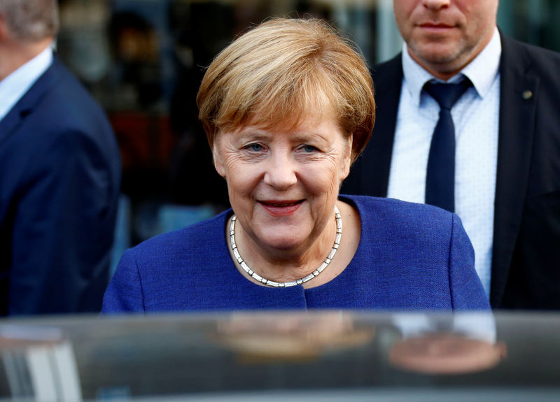 © Reuters. German Chancellor Angela Merkel leaves an event of the Federation of German Wholesalers and Retailers (BGA) in Berlin