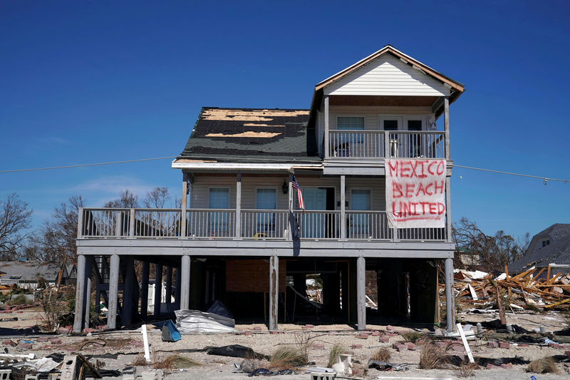 © Reuters. A sign is pictured on a damaged building following Hurricane Michael in Mexico Beach