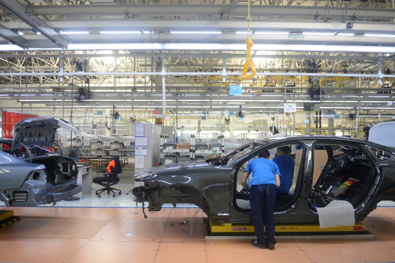 © Reuters. Men work on a car at the assembly line of the Volvo Cars manufacturing plant in Daqing