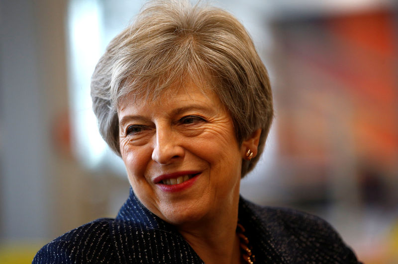 © Reuters. Britain's Prime Minister Theresa May talks to employees at WPP who have come through micro fellowships and apprenticeships, after a roundtable meeting with business leaders, at the Southbank Centre in London