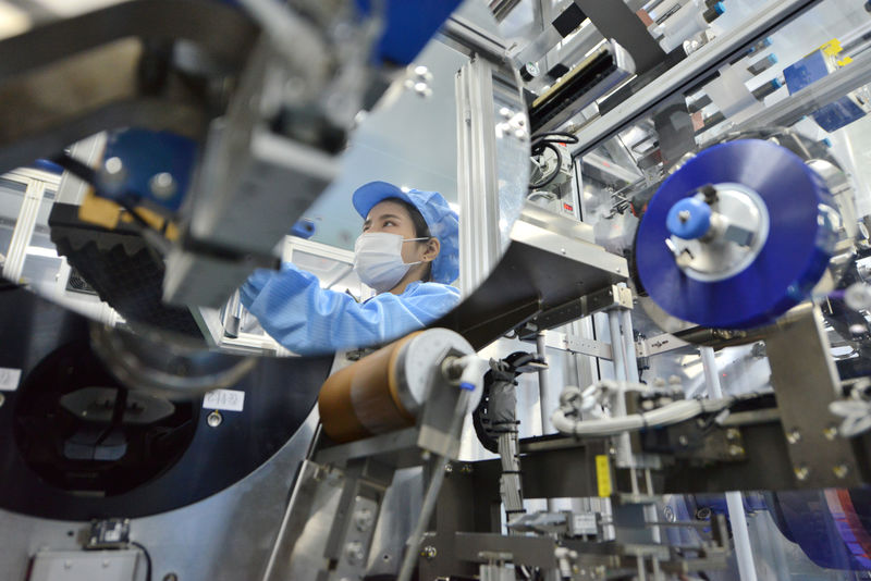 © Reuters. FILE PHOTO: Worker is seen at the production line of lithium-ion batteries for electric vehicles (EV) at a factory in Huzhou