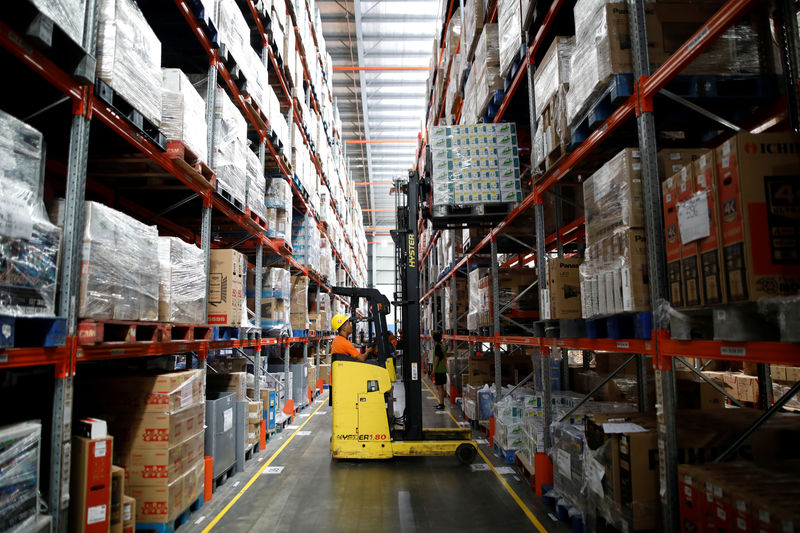 © Reuters. A worker uses a forklift to collect items at online retailer Lazada's warehouse in Depok