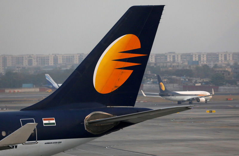 © Reuters. FILE PHOTO: A Jet Airways plane is parked as other moves to runway at the Chhatrapati Shivaji International airport in Mumbai