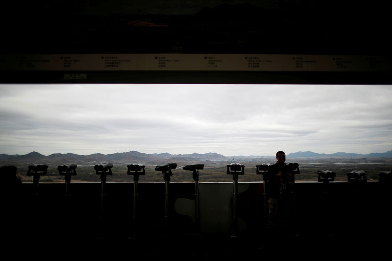© Reuters. A man stands near binoculars as he tries to see North Korea's propaganda village of Gijungdong at the Dora observatory near the demilitarised zone separating the two Koreas, in Paju