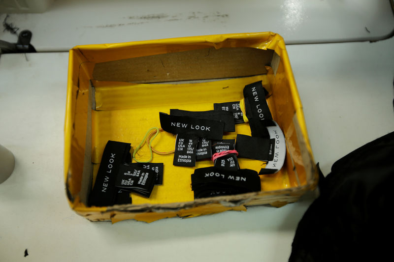 © Reuters. FILE PHOTO: New Look cloth tags are seen in a box at the Indochine Apparel PLC textile factory in Hawassa Industrial Park in Southern Nations, Nationalities and Peoples region