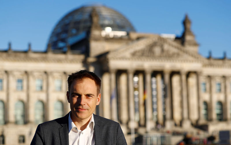 © Reuters. Gerhard Schick of the Green party and member of German lower house of Parliament Bundestag poses in front of the Reichstag building in Berlin