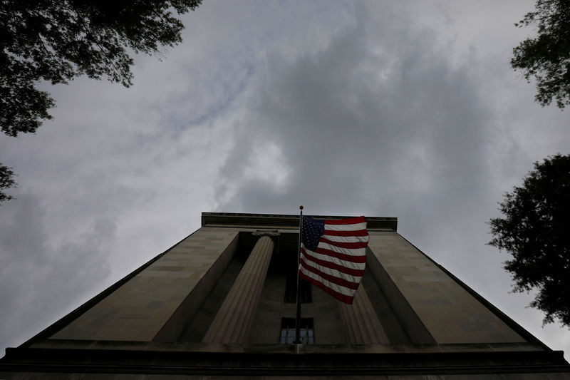 © Reuters. A U.S. flag flies at the headquarters of the Department of Justice in Washington