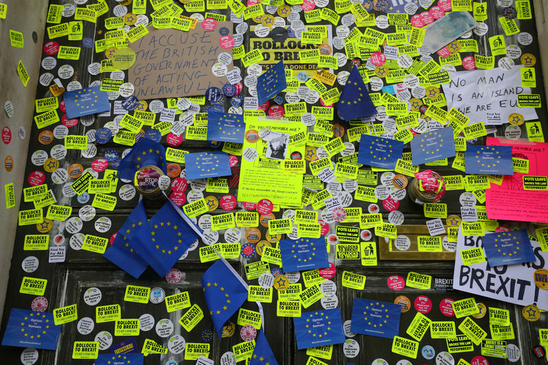 © Reuters. Stickers are seen attached to the Cabinet Office exterior door after an anti-Brexit march through central London