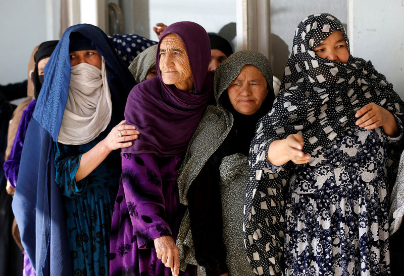 © Reuters. Afghan women line up to cast their votes during a parliamentary election at a polling station in Kabul, Afghanistan