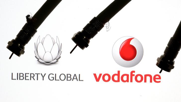 © Reuters. Coaxial TV Cables are seen in front of Vodafone and Liberty Global logos in this illustration