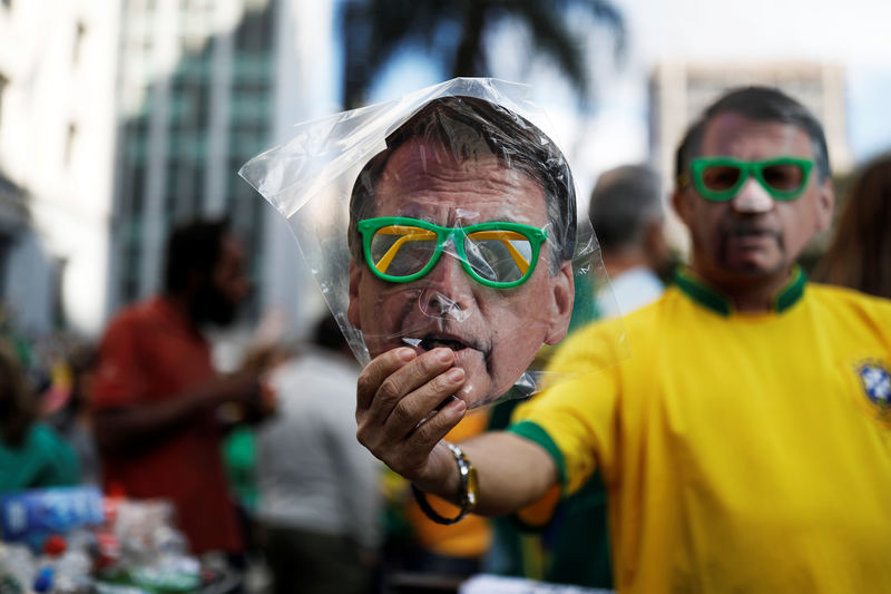 © Reuters. Homem vende máscara de Jair Bolsonaro durante manifestação em apoio ao candidato do PSL à presidência em São Paulo