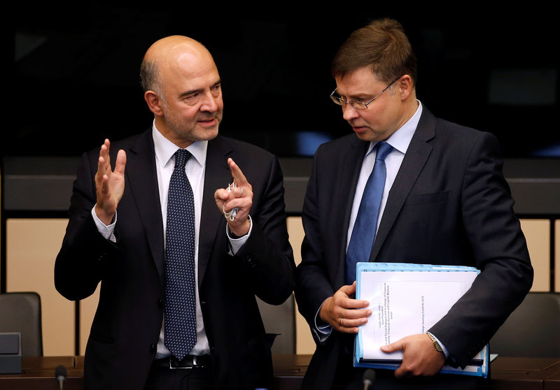 Â© Reuters. European Economic Commissioner Moscovici talks with European Commission Vice-President Dombrovskis as they arrive to take part in a weekly college meeting of the European Commission in Strasbourg