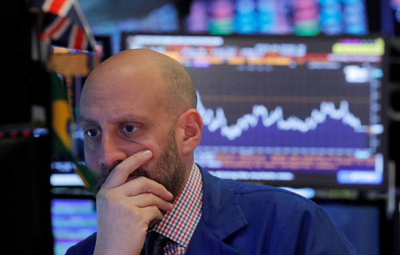 © Reuters. FILE PHOTO: A trader works on the floor of the New York Stock Exchange in New York