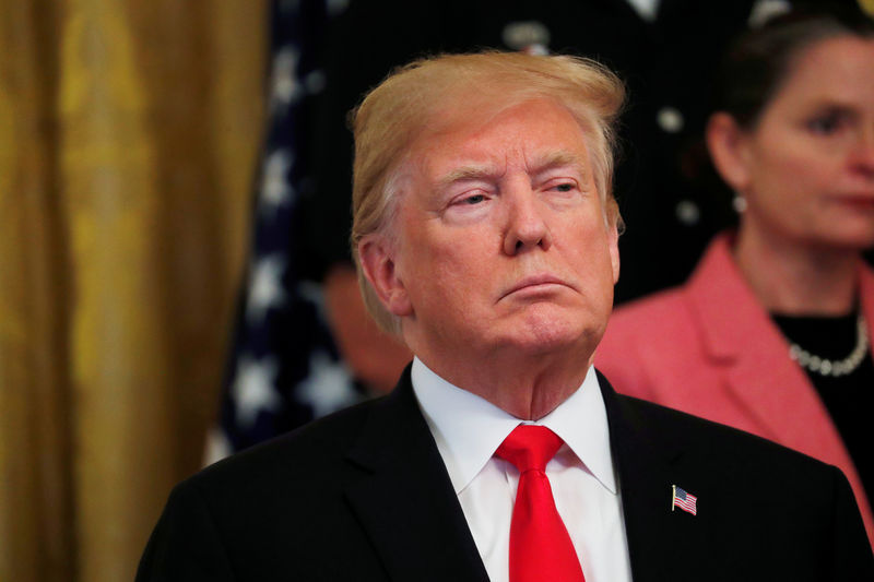 © Reuters. President Trump,listens as first lady Melania Trump speaks about bombs sent to political figures during opioid event the White House in Washington