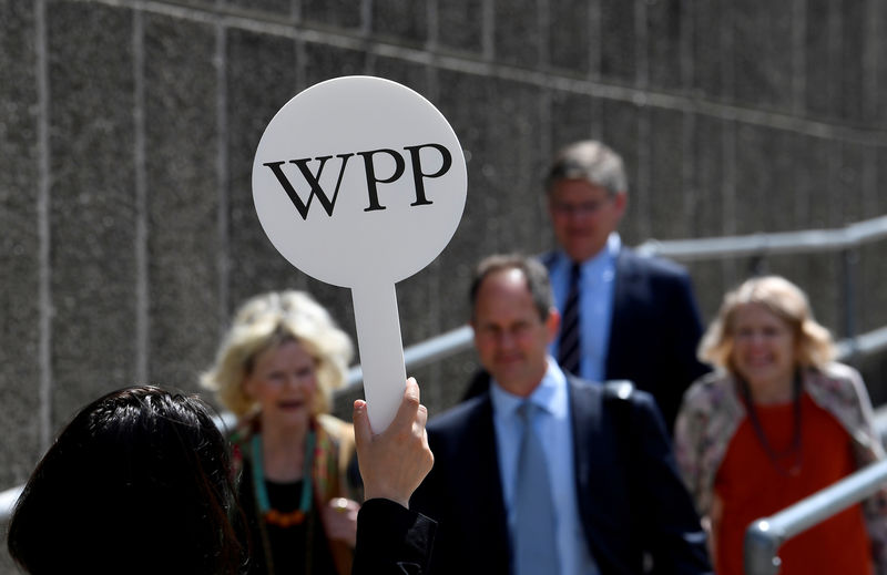 © Reuters. FILE PHOTO: An usher holds a baton to guide attendees towards the AGM of advertising agency WPP in London, Britain