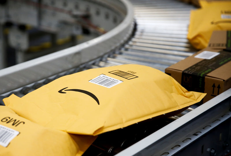 © Reuters. Packages go on an automated conveyor line to be scanned, weighed and labeled at the Amazon fulfillment center in Kent