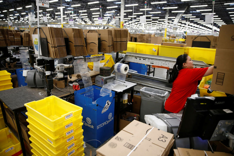 © Reuters. Employee Jimenez works at a packing station at the Amazon fulfillment center in Kent