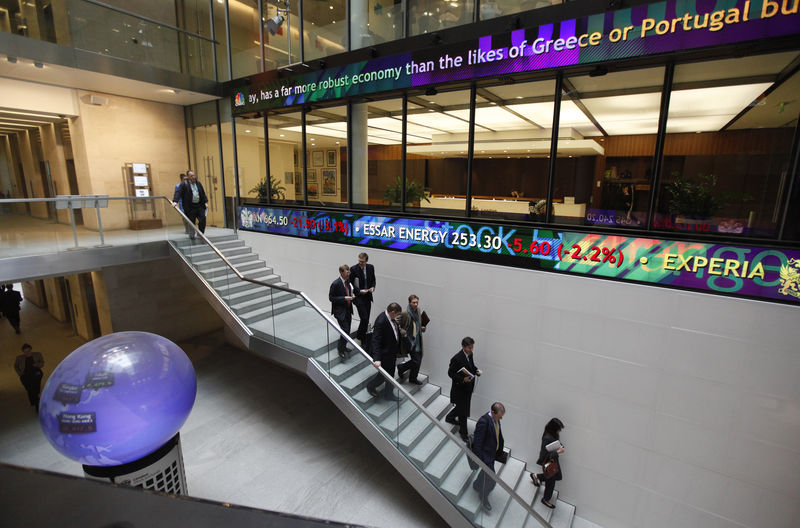 © Reuters. People walk down a stairway inside the London Stock Exchange Atrium in London