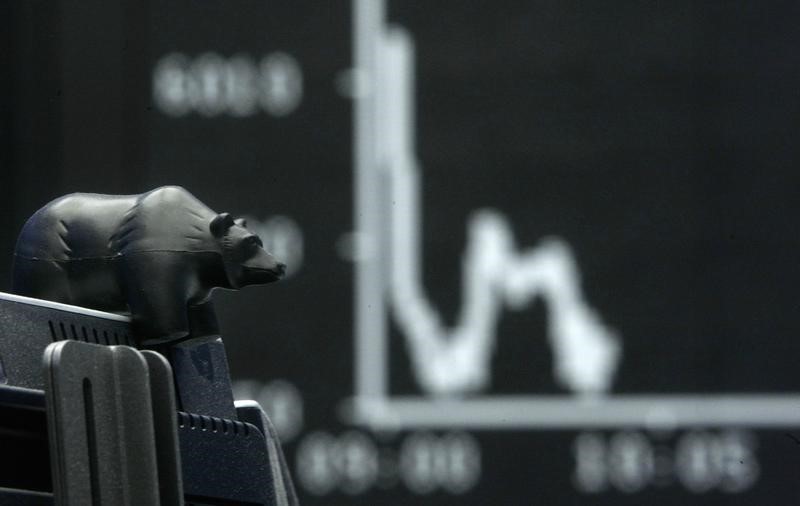 © Reuters. A plastic bear sits on a computer screen in front of the DAX board at the Frankfurt stock exchange