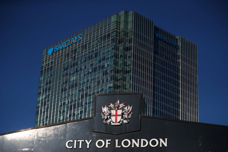 © Reuters. Barclays' building in Canary Wharf is seen behind a City of London sign outside Billingsgate Market in London