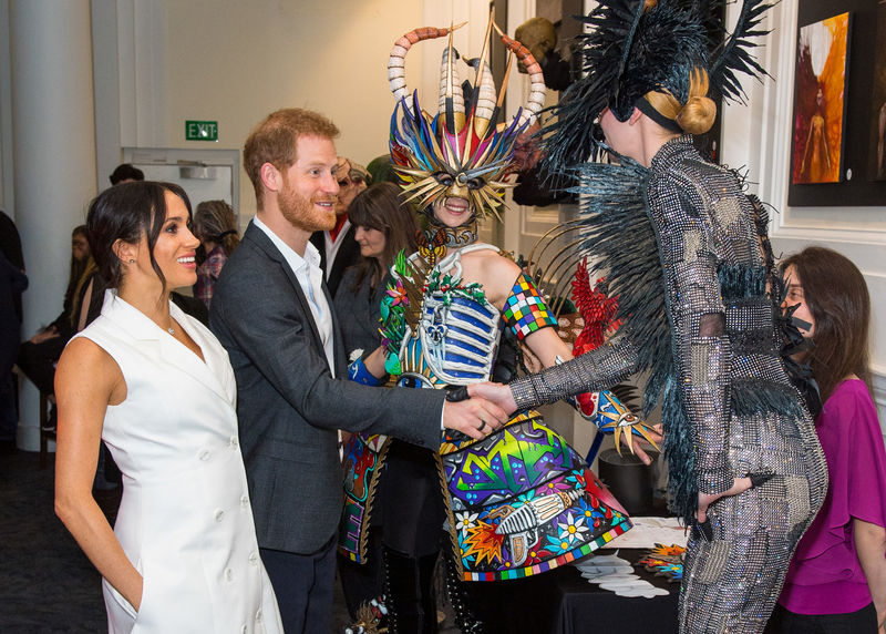 © Reuters. Britain's Prince Harry and Meghan, Duchess of Sussex, meet actors in costumes during a visit to Courtenay Creative, in Wellington