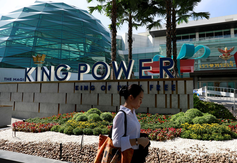 © Reuters. A woman walks in front of the King Power head office in Bangkok, Thailand