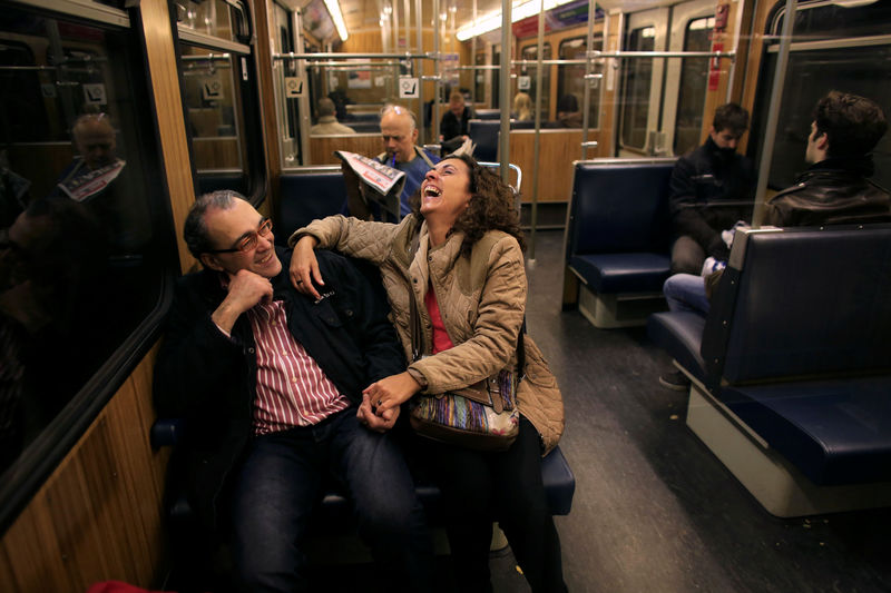 Â© Reuters. FILE PHOTO: Abel and his wife Oliva laugh as they sit on a train after she arrived from Spain to spend a week in Munich