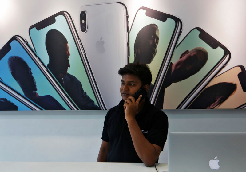 © Reuters. Salesperson speaks on the phone at an Apple reseller store in Mumbai