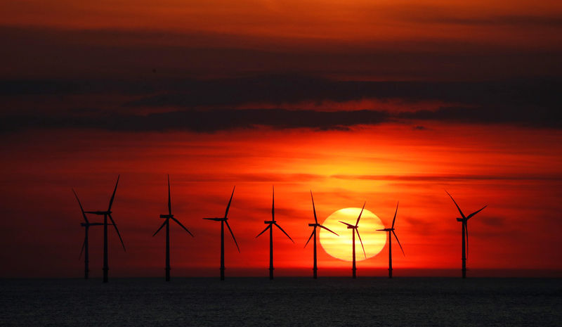 © Reuters. The sun sets behind the Burbo Bank wind farm near New Brighton.