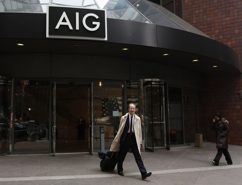 © Reuters. A man exits the AIG headquarters offices in New York's financial district