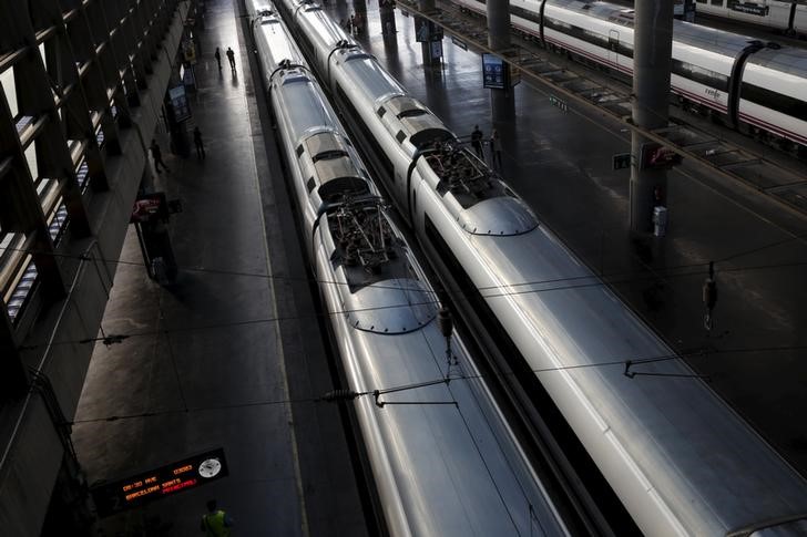 © Reuters. Two delayed Barcelona bound AVE high speed trains wait to depart at Atocha train station in Madrid