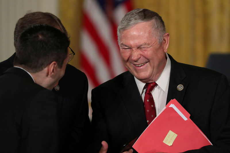 © Reuters. FILE PHOTO: U.S. Representative Dana Rohrabacher speaks with fellow attendees before President Donald Trump's remarks at a meeting of the National Space Council at the White House in Washington