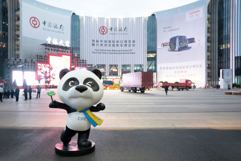 © Reuters. Statue of the China International Import Expo (CIIE)'s mascot is placed in front of a building hanging advertisement of Bank of China, at the venue for the expo in Shanghai