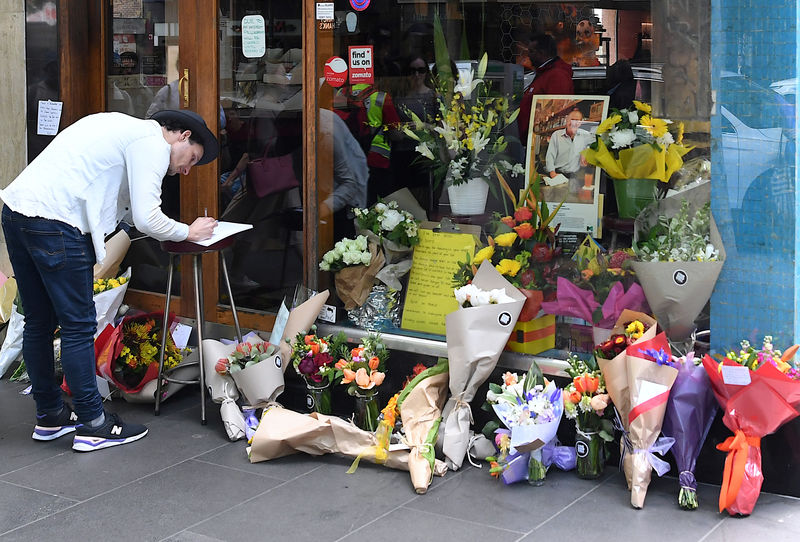 © Reuters. Floral tributes can be seen outside Melbourne's Pellegrini's Cafe for Sisto Malaspina, the day after he was stabbed to death in an attack police have called an act of terrorism, in central Melbourne