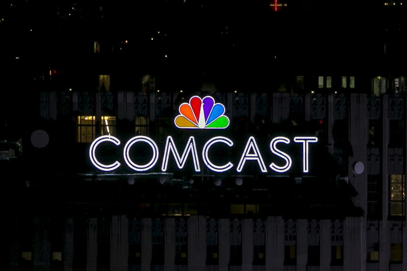 © Reuters. The NBC and Comcast logo are displayed on top of 30 Rockefeller Plaza, formerly known as the GE building, in midtown Manhattan in New York