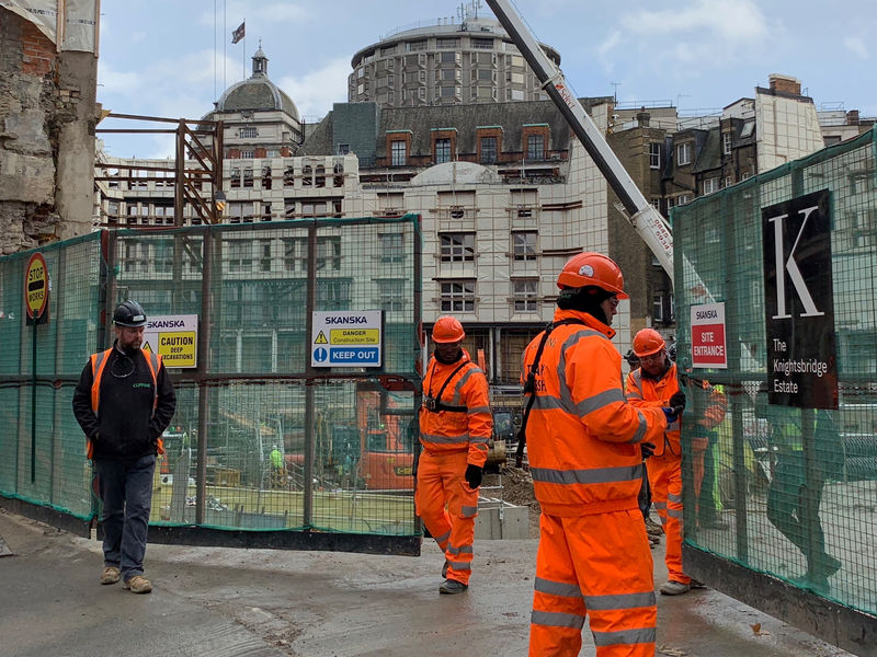 © Reuters. Labourers work at the Swedish builder Skanska building site on Brompton Road in London
