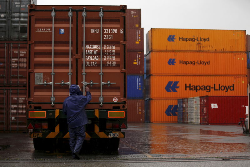 © Reuters. A man works at a container area at a port in Tokyo