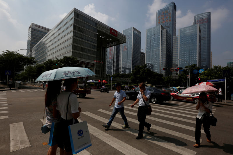 © Reuters. FILE PHOTO: People cross a street at Nanshan district focusing on technology sectors in Shenzhen