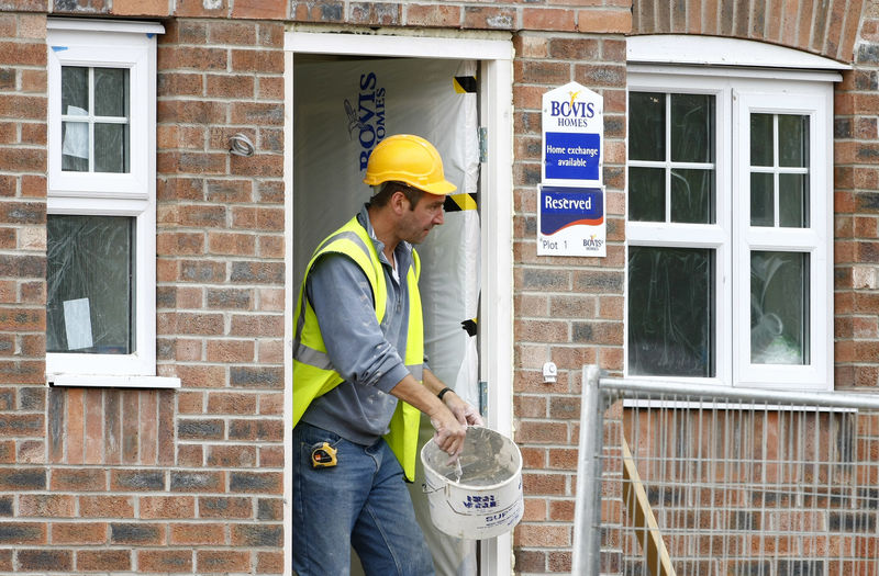 © Reuters. A builder works at a Bovis homes housing development near Bolton