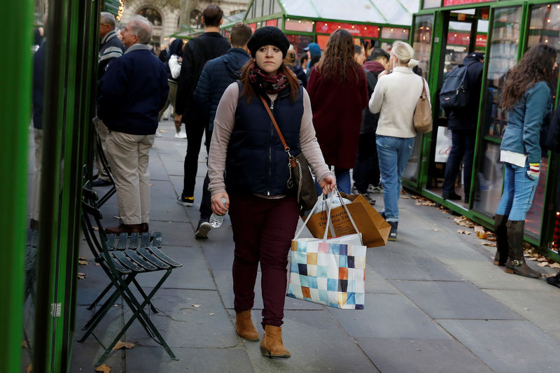 © Reuters. FILE PHOTO: A woman walks with shopping bags at Bryant Park in New York