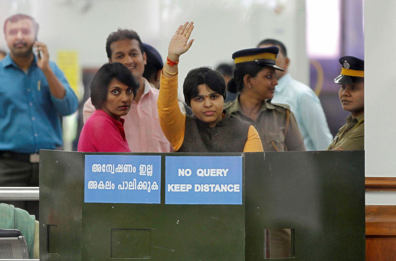 © Reuters. Trupti Desai, a women's rights activist, waves from inside the Cochin International Airport at Kochi