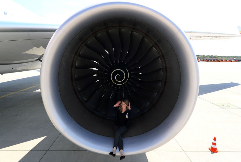 © Reuters. FILE PHOTO: PR agent Elsa Goette sits in a Rolls-Royce engine of an Airbus A350-900 of Ethiopian Airlines during a site-inspection at Fraport airport in Frankfurt