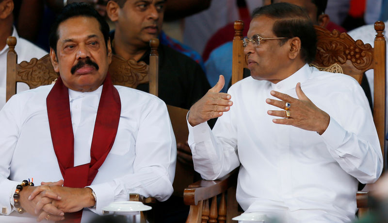 © Reuters. FILE PHOTO: Sri Lanka's newly appointed Prime Minister Rajapaksa and President Sirisena talk during a rally near the parliament in Colombo