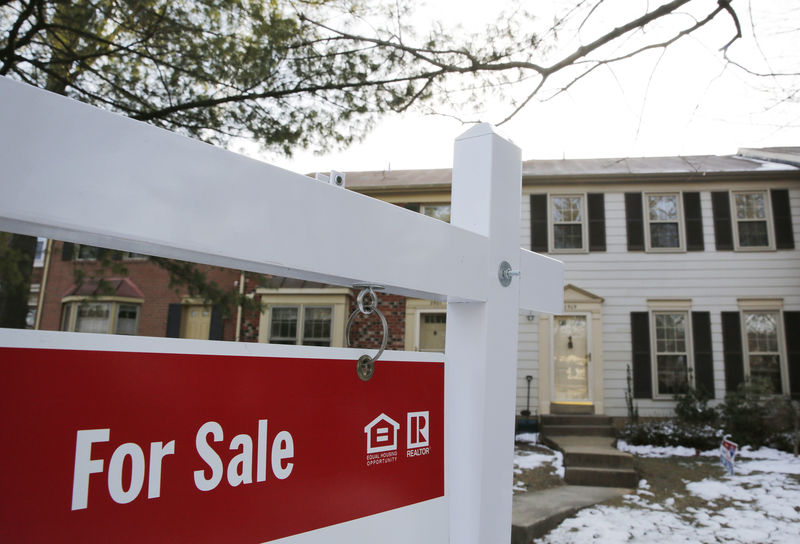 © Reuters. FILE PHOTO: Home for sale sign hangs in front of a house in Oakton, on the day the National Association of Realtors issues its Pending Home Sales for February report, in Virginia