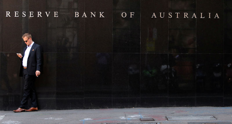 © Reuters. FILE PHOTO:  A man smokes next to the Reserve Bank of Australia headquarters in central Sydney
