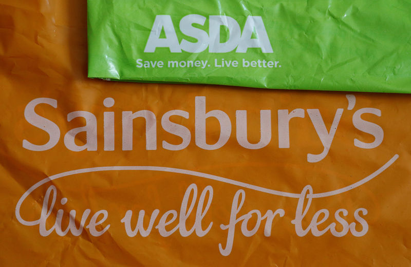 © Reuters. Shopping bags from Asda and Sainsbury's are seen in Manchester.