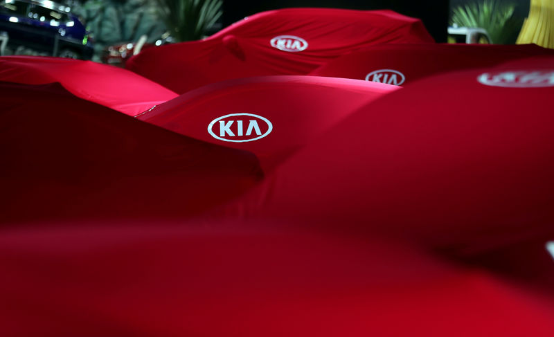 © Reuters. FILE PHOTO: Covered Kia cars are pictured during the Salao do Automovel International Auto Show in Sao Paulo