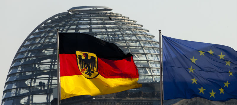 © Reuters. German national flag and European flag fly in front of Reichstag cupola in Berlin