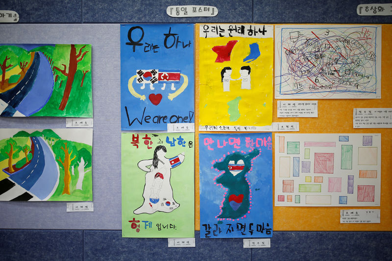 © Reuters. FILE PHOTO: Posters bearing messages, wishing unification between the two Koreas, hang on a wall at the Daesungdong Elementary School, a school inside the demilitarised zone separating the two Koreas, in Paju
